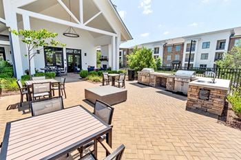 Outdoor kitchen and dining patio with grilling stations